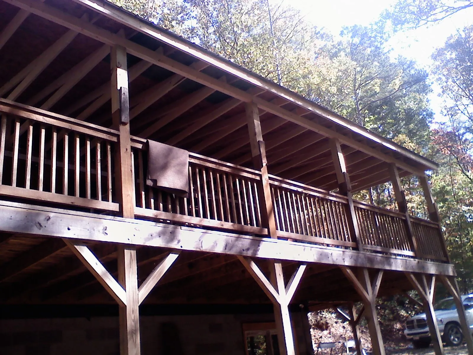 Timber framing under a new elevated porch and deck — Roof Leak Repair in Grand Valley by Roofing Brothers